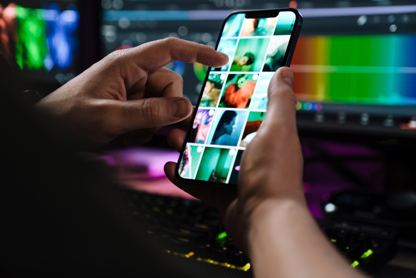 Ruky prezerajú náhľady fotografií na displeji mobilného telefónu